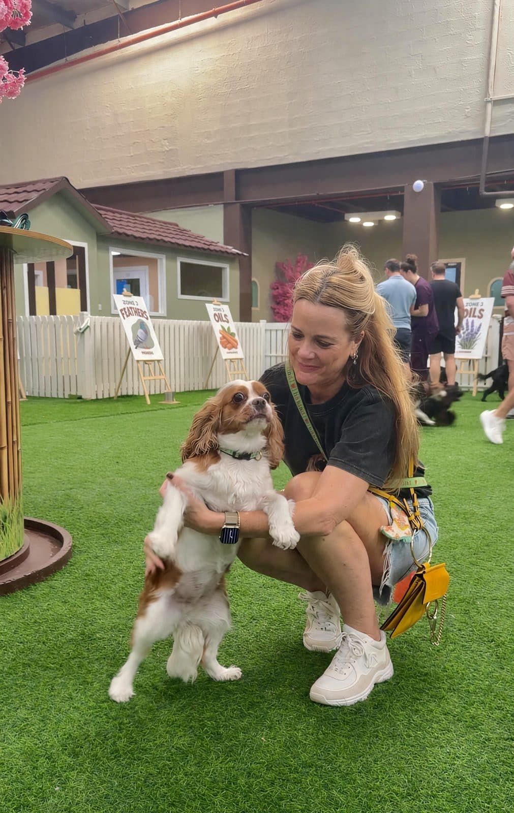 A woman hugging a cavalier King Charles spaniel