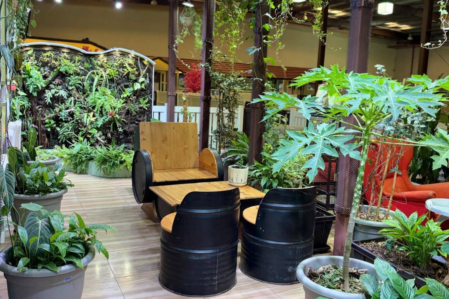 The Flagship Nature lounge: barrel seats among plants beside a living wall